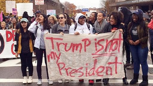 People protest on the University of Connecticut campus against the election of Republican Donald Trump as President on Wednesday, 9 November 2016. (Photo: AP)