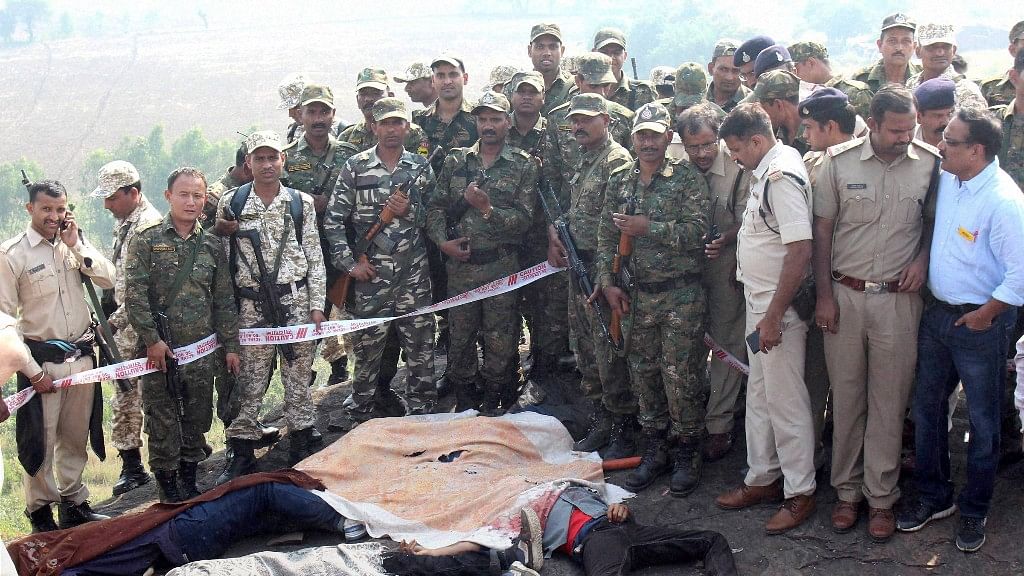  Police at the encounter site at the hillocks of Acharpura village after the STF killed 8 SIMI activists. (Photo: PTI)