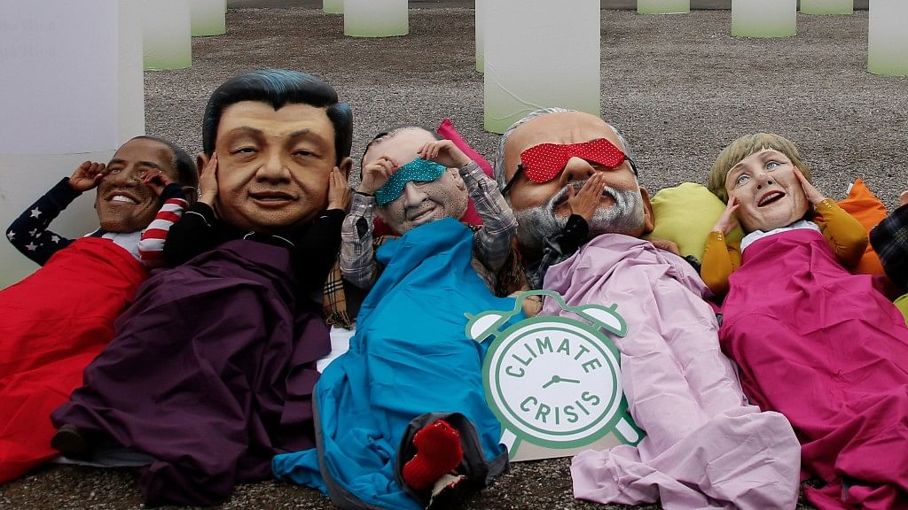 Activists of global anti-poverty charity Oxfam wearing masks depicting some of the world leaders  outside the venue of the World Climate Change Conference 2015 (COP21). (Photo: REUTERS/Jacky Naegelen)