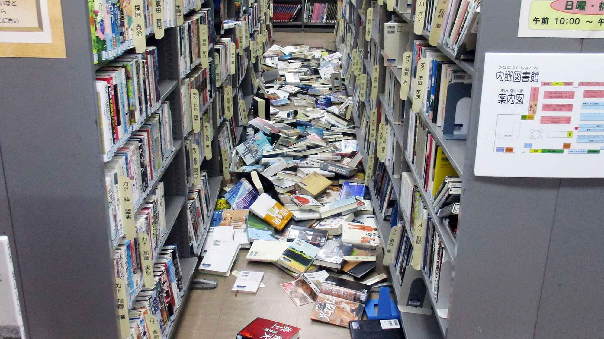 Books are scattered on the floor at a library in Iwaki, Fukushima prefecture (Photo: AP)