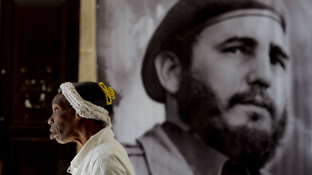 A woman walks past a photo of Fidel Castro at a memorial to honour him in Guanabacoa on the outskirts of Havana, Cuba, on Monday. (Photo: AP)