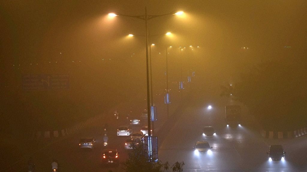 Vehicles ply on smog covered street in New Delhi on Saturday. (Photo: PTI)