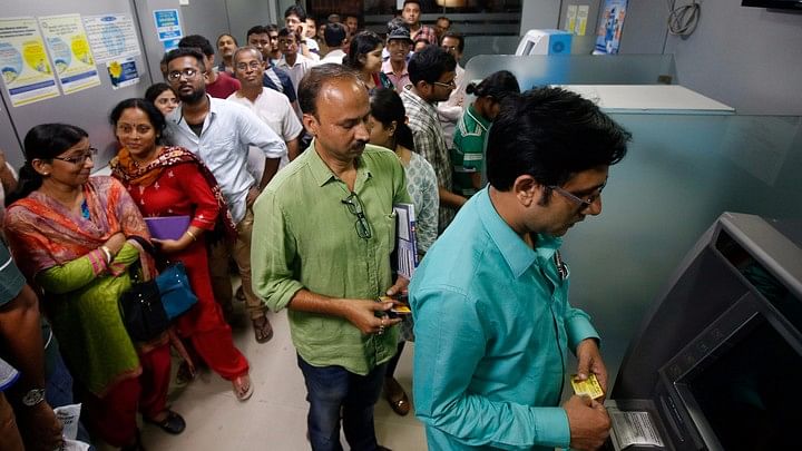People queuing outside an ATM. (Photo: Reuters)