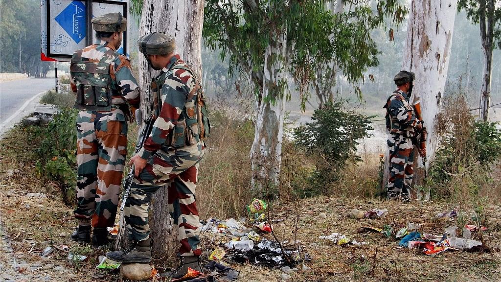 Security personnel take position during the gun-battle with terrorists at Nagrota army camp. (Photo: PTI)