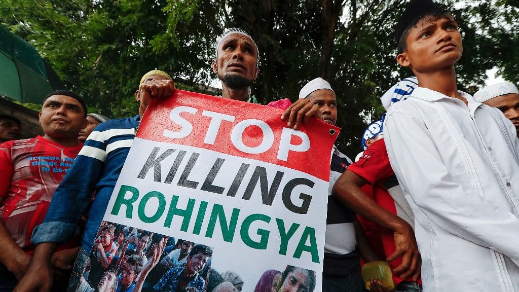 An ethnic Rohingya holds a banner during protest after Friday prayers outside the Myanmar Embassy in Kuala Lumpur, Malaysia.&nbsp;(Photo: AP)