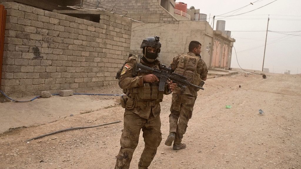 File image of Iraqi special forces soldiers try to find cover as they take fire from ISIS militants.&nbsp;