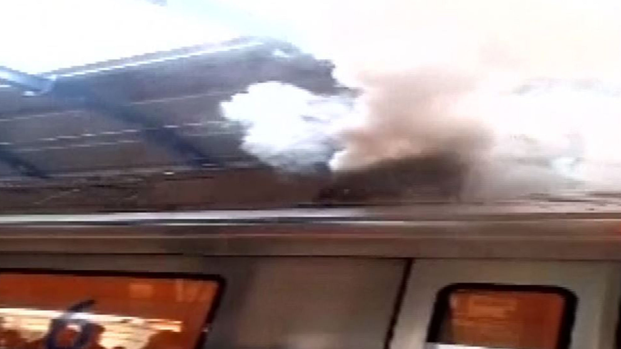 Smoke bellows out of a  Delhi Metro rake at Patel Nagar on Thursday. (Photo: ANI Screengrab)