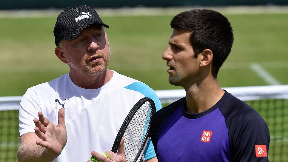 Novak Djokovic (R) of Serbia speaks with his coach Boris Becker during a training session ahead of Wimbledon in 2014. (Photo: Reuters)