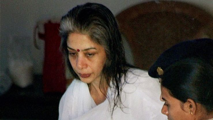 Indrani Mukerjea being escorted by police for her father’s last rites. (Photo: PTI)