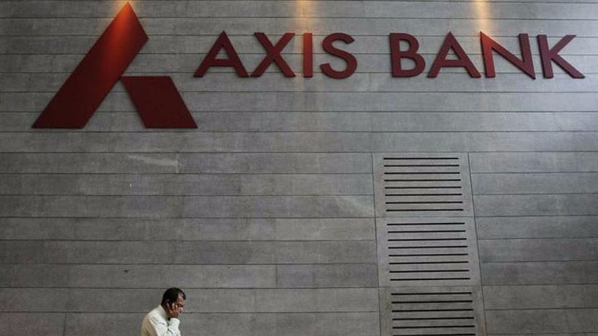An employee walks in front of an Axis Bank sign. (Photo: Reuters)