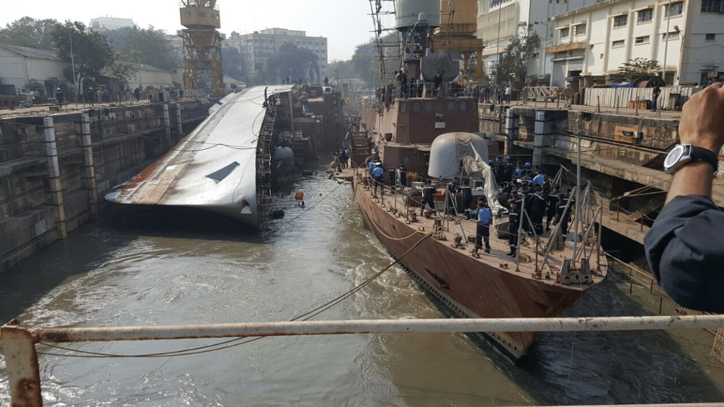 INS Betwa, undergoing a refit at the dry dock here, slipped and toppled over on her side, killing two sailors and injuring 14 naval personnel.  (Photo Courtesy: Twitter/<a href="https://twitter.com/jrpur">‏@<b>jrpur</b></a>)