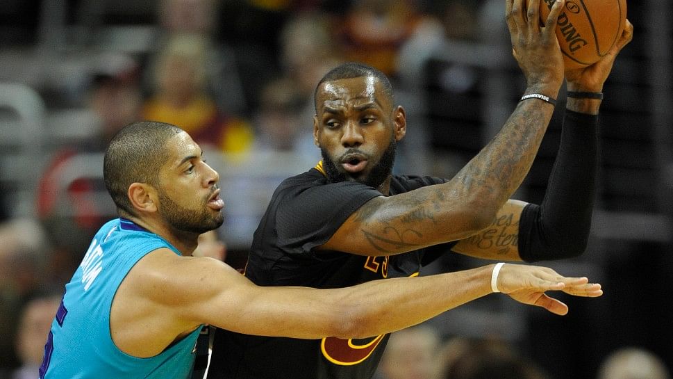 Charlotte Hornets’ guard Nicolas Batum (5) defends Cleveland Cavaliers’ forward LeBron James (23) in the first quarter at Quicken Loans Arena. (Photo: Reuters)