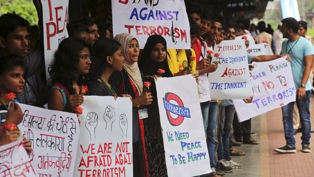 

College students hold placards during a rally to condemn terrorism at a railway platform in Mumbai. As many as 797 terrorist attacks were recorded in India in 2015, up 4% since 2014. (Photo Courtesy: IndiaSpend)