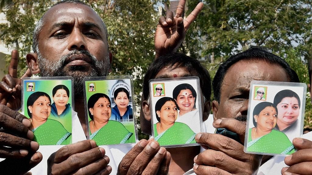 People hold up cards showing Sasikala Natarajan with late Tamil Nadu CM J Jayalalithaa in Chennai. (Photo: PTI)