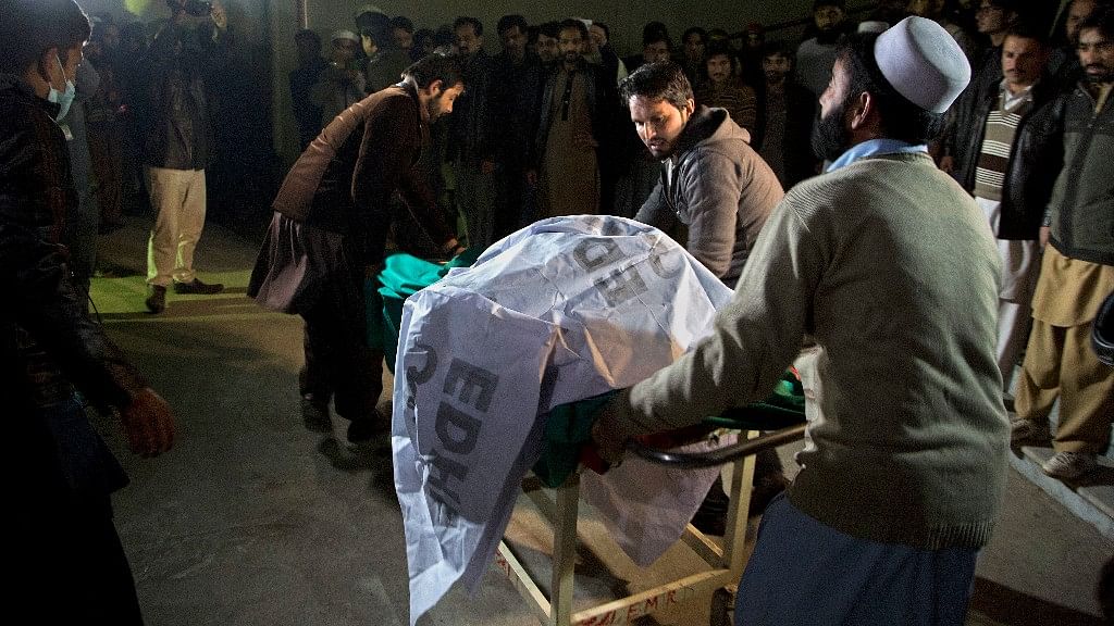 Pakistani volunteers move remains of plane crash victims to a mortuary at a hospital, in Abbottabad, Pakistan. (Photo: AP)