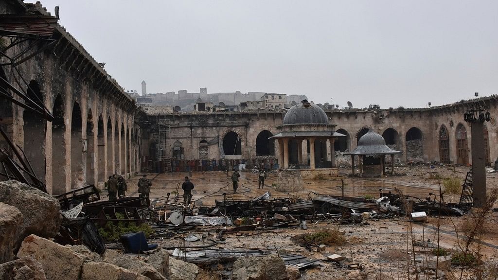 This photo released by the Syrian official news agency SANA, shows Syrian troops and pro-government gunmen marching walk inside the destroyed Grand Umayyad mosque. (Photo: AP)