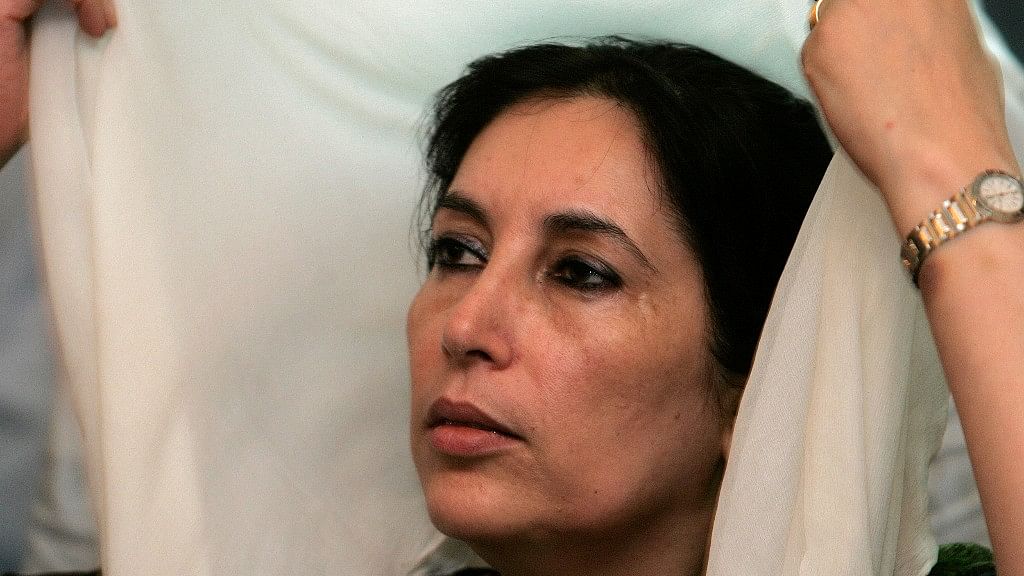 Pakistan’s former prime minister Benazir Bhutto holds her headscarf as she talks to members of the media at her residence in Karachi on 22 October  2007.