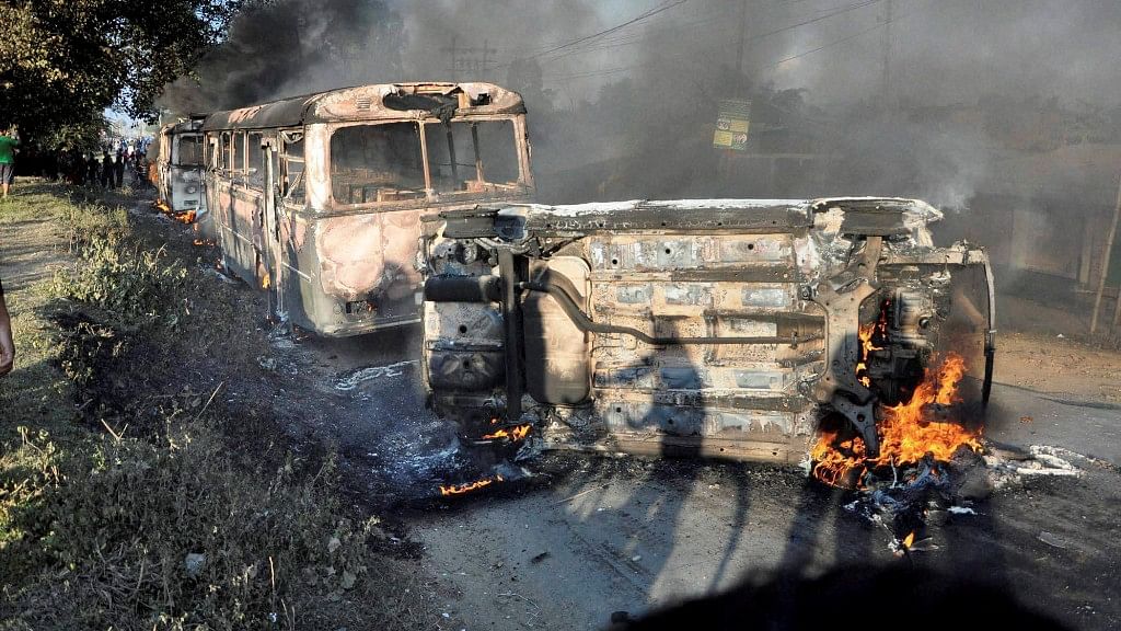 Angry people set on fire vehicles in Imphal East district on Sunday in protest against the United Naga Council (UNC)’s indefinite economic blockade. (Photo: PTI)
