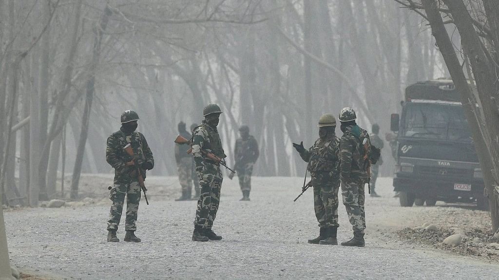 Security jawans stand guard during an encounter between army and militants at Arwani in Anantnag district of South Kashmir on Thursday, 8 December 2016. (Photo: PTI)
