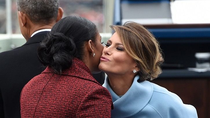 First lady Melania Trump kisses former first lady Michelle Obama on Capitol Hill in Washington, on Friday. (Photo: AP)