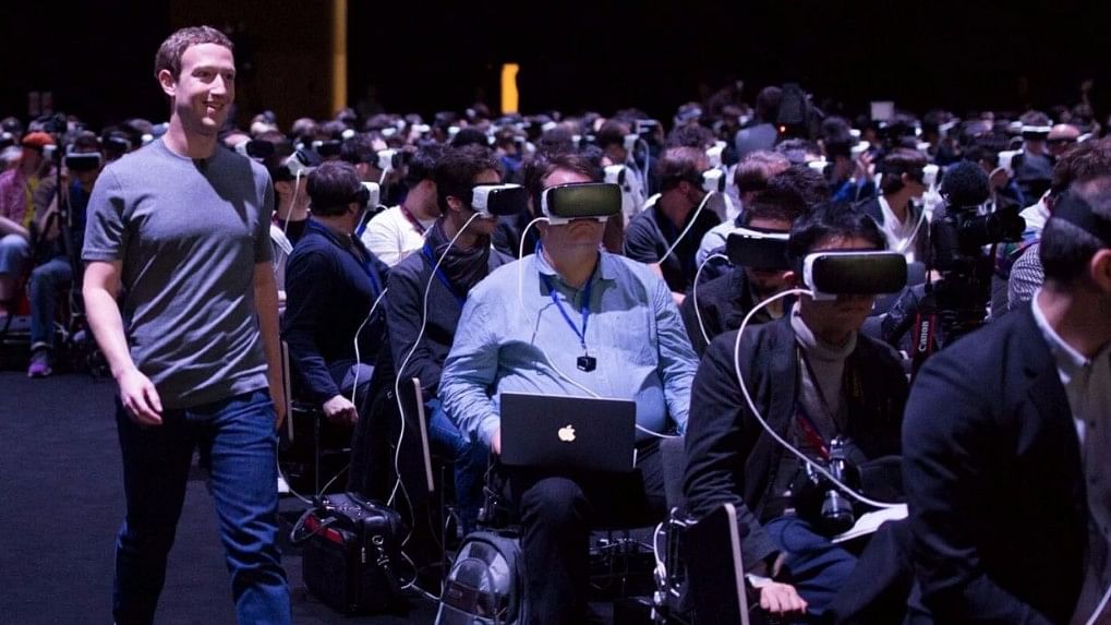 Mark Zuckerberg, walking around a crowd immersed in virtual reality.&nbsp;