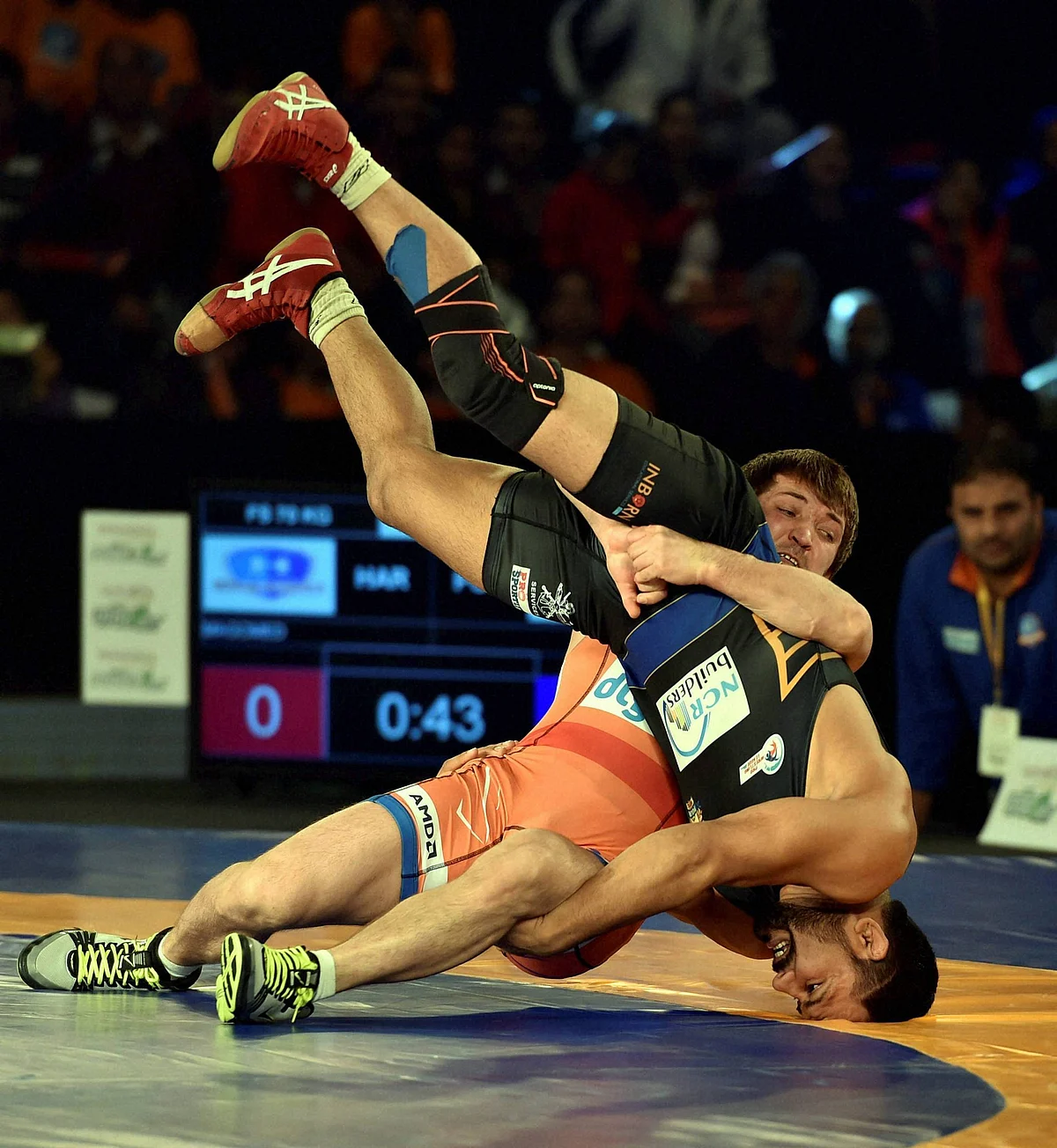 Haryana Hammers’ Vladimir Khinchegashvili (red) competes against Sandeep Tomar of Punjab Royals in the men’s 57 kg category. (Photo: PTI)