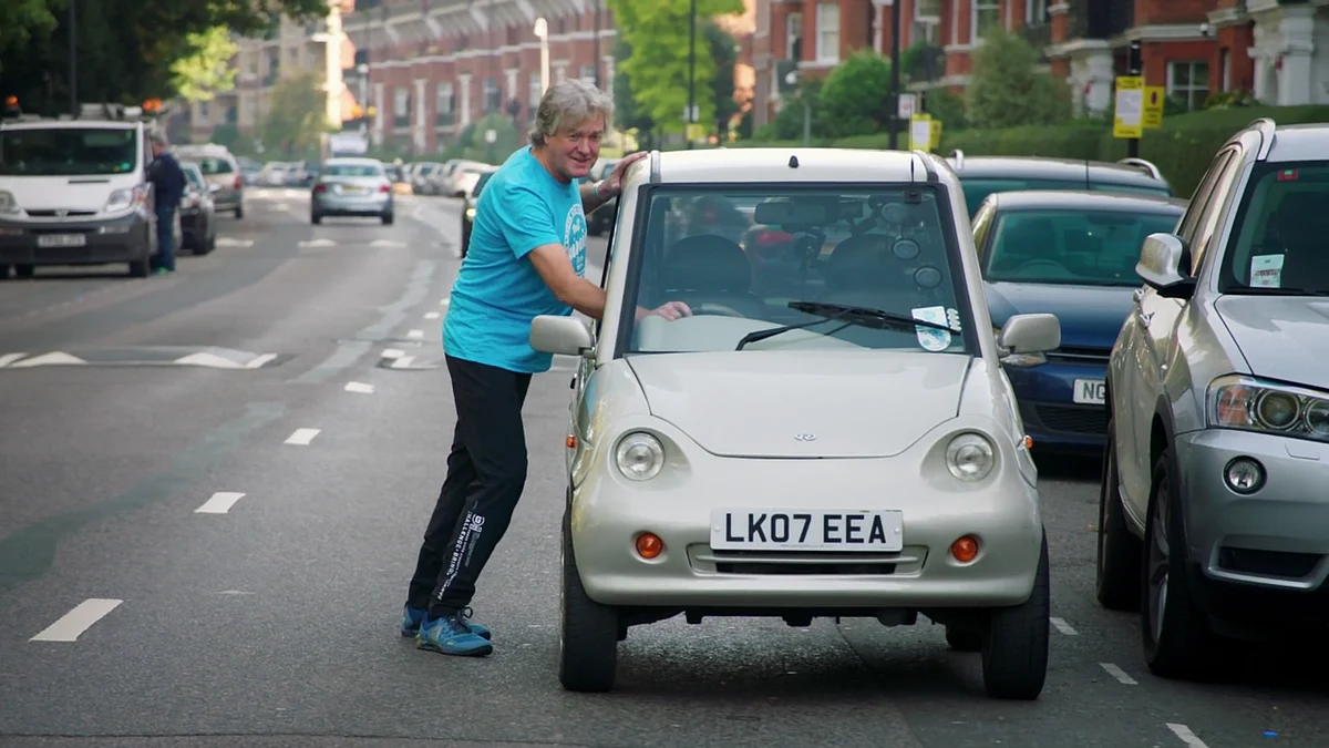 With no power left in the car, May had to push it himself. (Photo Courtesy: Amazon screen grab)