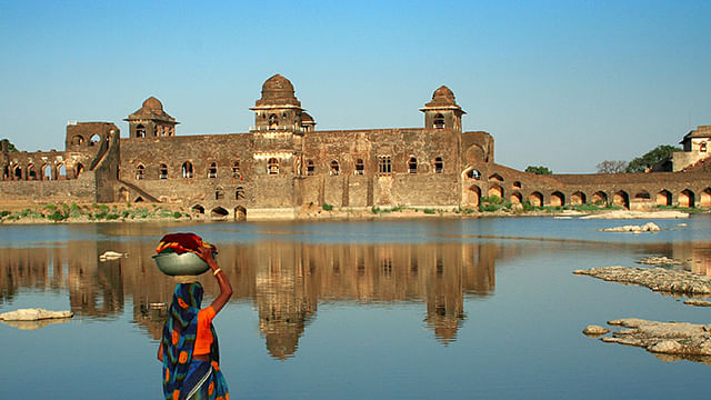 Floating over it’s own reflection, the Jahaz Mahal in Mandu looks like a ship that’s about to sail. (Photo: MP Tourism)&nbsp;