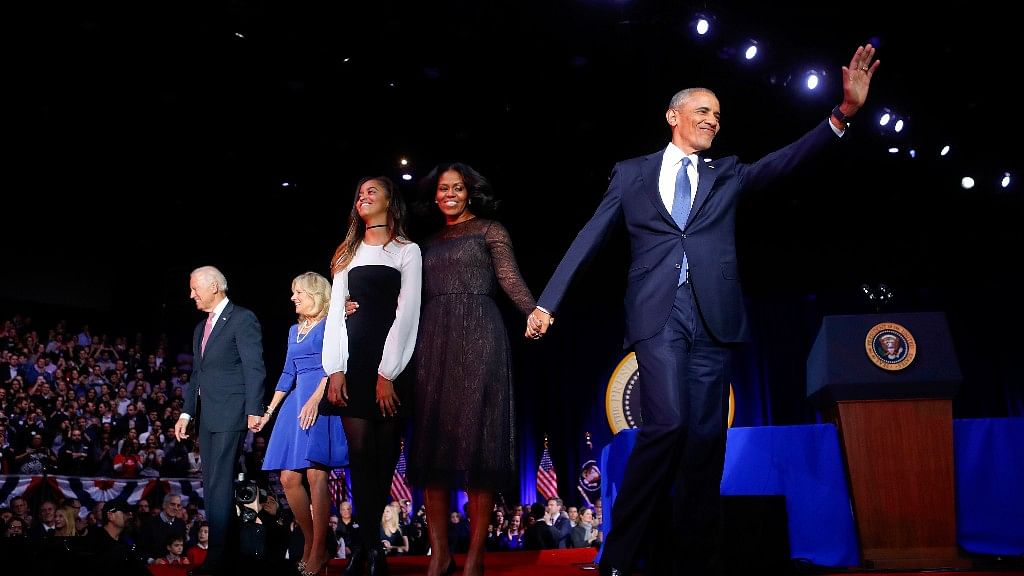 President Barack Obama waves on stage with first lady Michelle Obama, daughter Malia, Vice President Joe Biden and his wife Jill Biden. (Photo: AP)