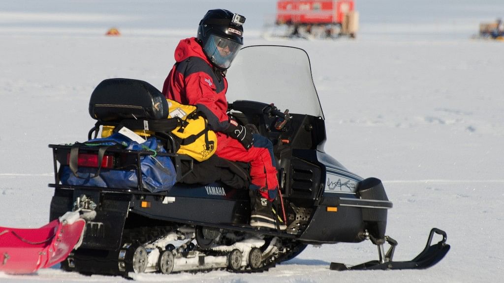 Vikram Goel returns to his research camp on a snowmobile in Antarctica. (Photo Courtesy: Norwegian Polar Institute/Peter Leopold)
