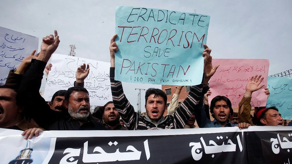 Protesters hold placards and chant slogans against the recent bomb blasts in various parts of Pakistan during a protest in Peshawar, Pakistan. (Photo: Reuters)