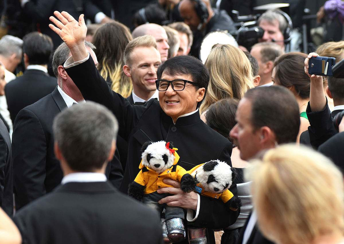 

Jackie Chan walks the Oscars red carpet with two ‘awwdorable’ panda bears.