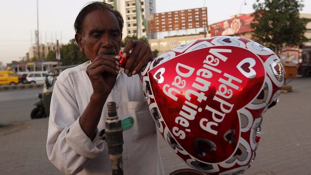 A vendor inflates a heart-shaped balloon from his cart ahead of Valentine’s Day along a road in Karachi, Pakistan in this picture taken in February 2016. (Photo: Reuters)