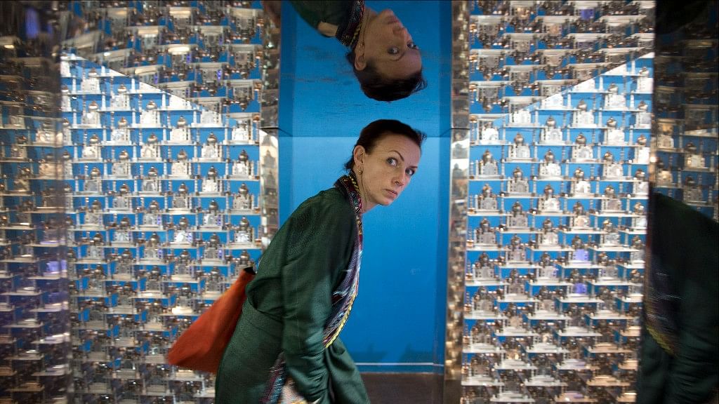 

A woman looks inside an art installation titled <i>Taj</i> by Sudarshan Shetty during the IndiaArt Fair in New Delhi, India, on Thursday. (Photo: AP)