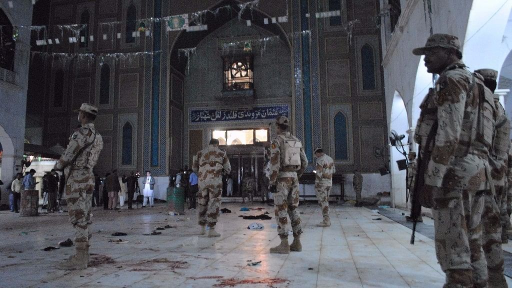 Pakistani para-military soldiers stand alert after a deadly suicide attack at the shrine of famous Sufi Lal Shahbaz Qalandar in Sehwan, Pakistan, on Thursday. (Photo: AP)