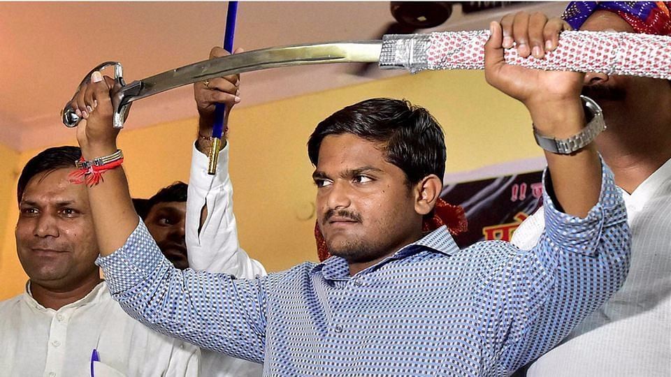 Hardik Patel brandishes a sword presented to him by Gujjars in New Delhi. (Photo: PTI)