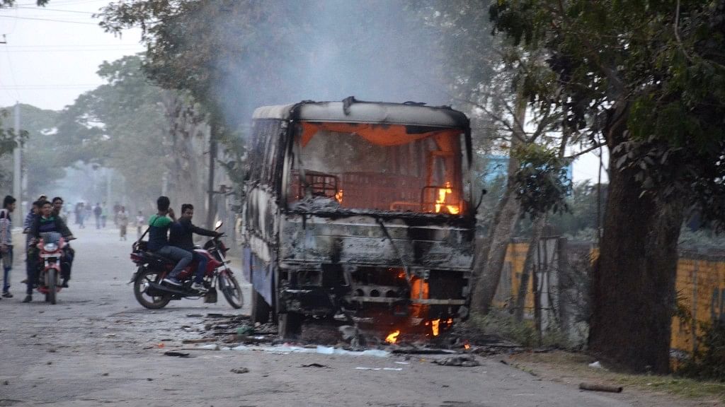 A bus torched by people staging a demonstration against a proposed power substation project in West Bengal’s Bhangar on 17 January 2017. (Photo: IANS)