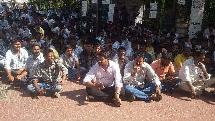 Over 300 drivers had gathered outside the office and sat in silent protest. (Photo Courtesy: The News Minute)