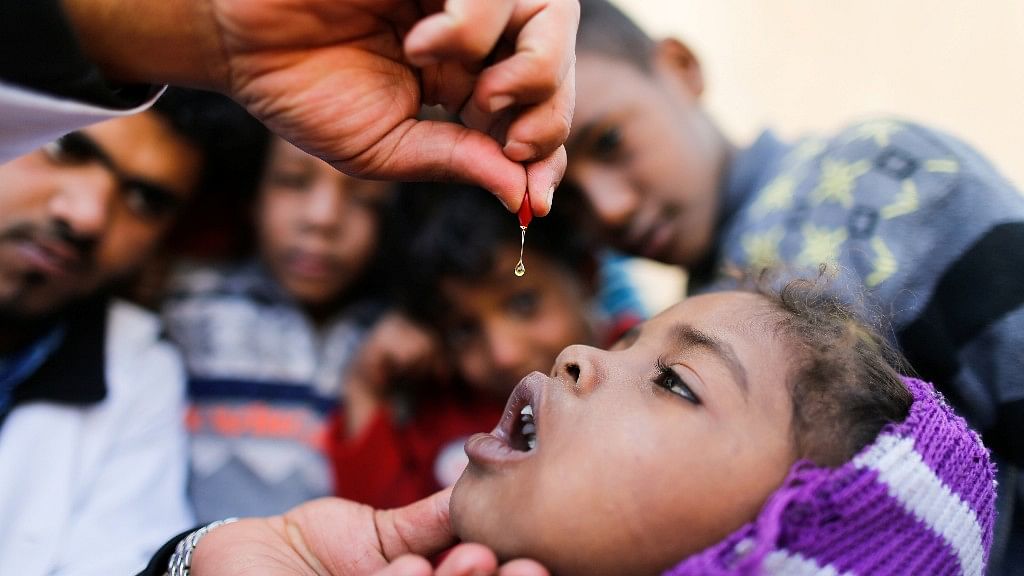 A girl is given vitamin A drops during a house-to-house vaccination campaign in Sanaa, Yemen. (Photo: Reuters)
