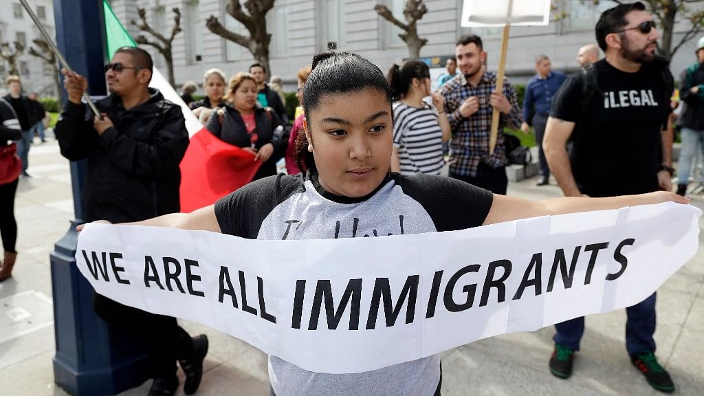 Delilah Gutierrez, 10, left, holds a sign during a protest against President Donald Trump’s efforts to crack down on immigration in San Francisco (Photo: AP)