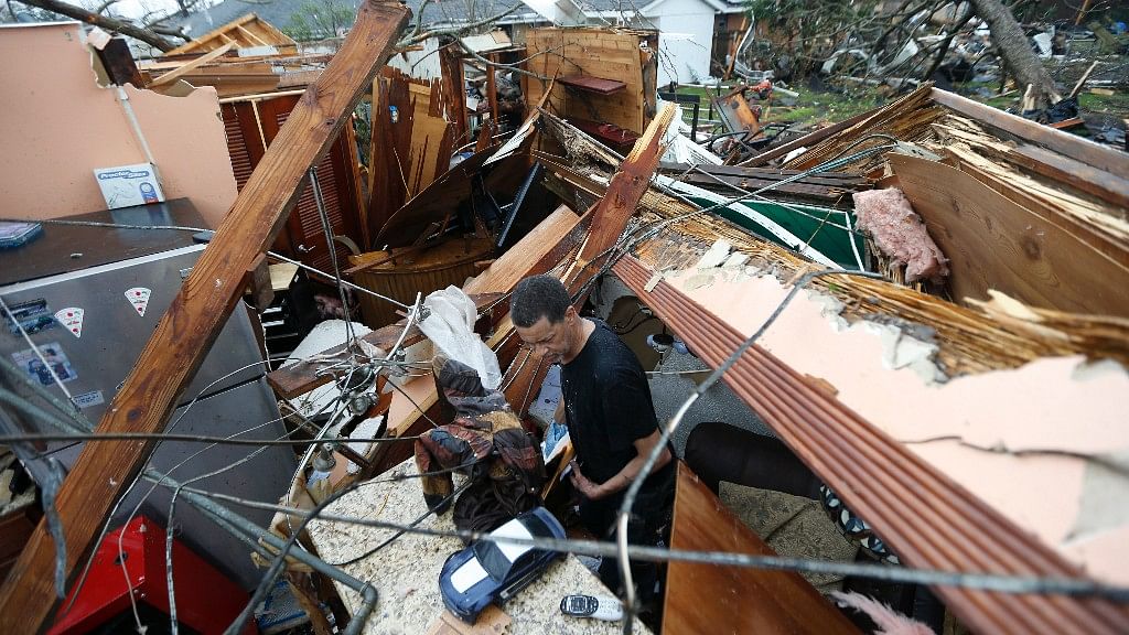 A man looks through the debris at his home after a tornado hit New Orleans, Louisinia. (Photo: AP)