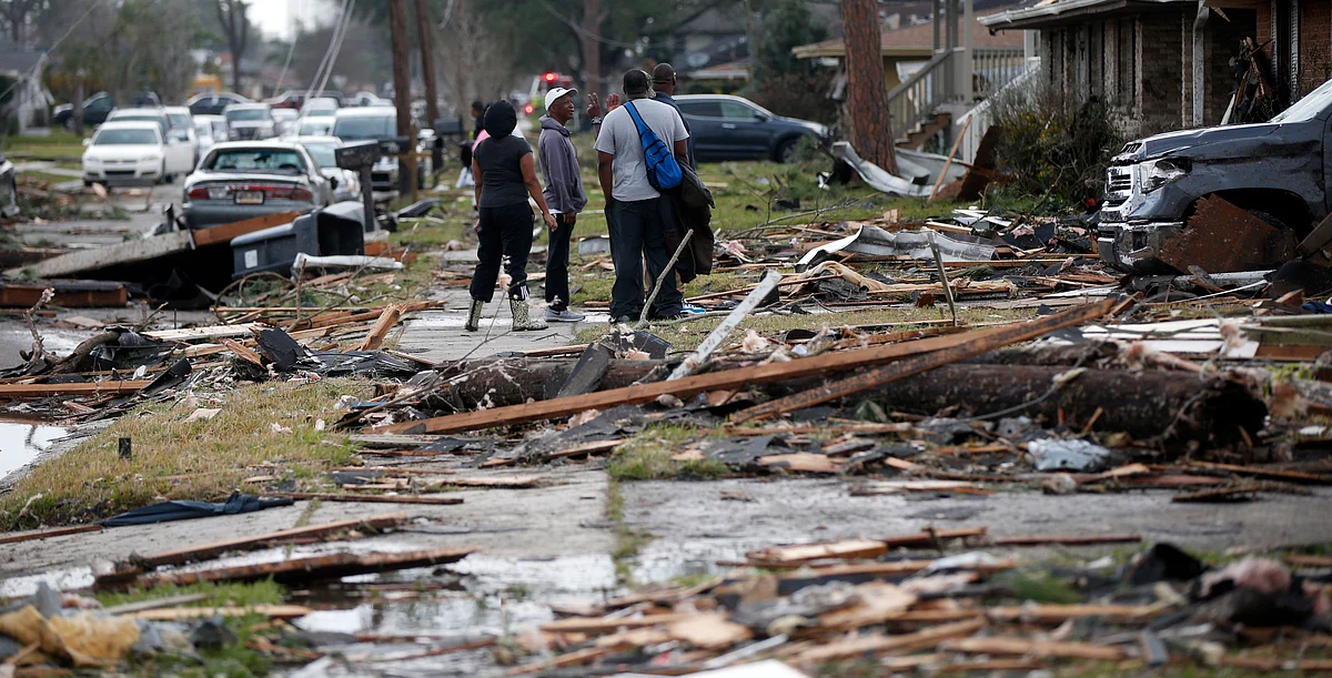 People walk amongst debris from destroyed homes after a tornado tore through the eastern neighbourhood in New Orleans. (Photo: AP)