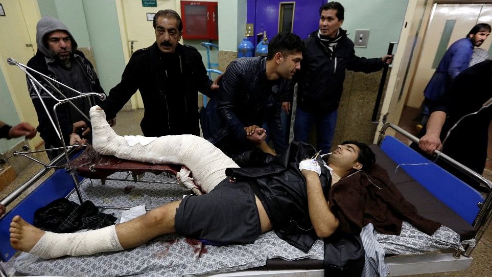 Men carry an injured man to a hospital after a bomb blast in Kabul, Afghanistan. (Photo: Reuters)
