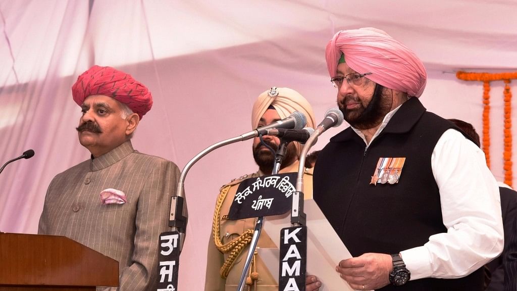 Punjab Governor VP Singh administer the oath to Captain Amarinder Singh as Chief Minister of Punjab during the swearing in ceremony in Chandigarh on 16 March 2017. (Photo: IANS) 