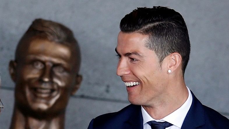 Cristiano Ronaldo with the statue. (Photo: Reuters)