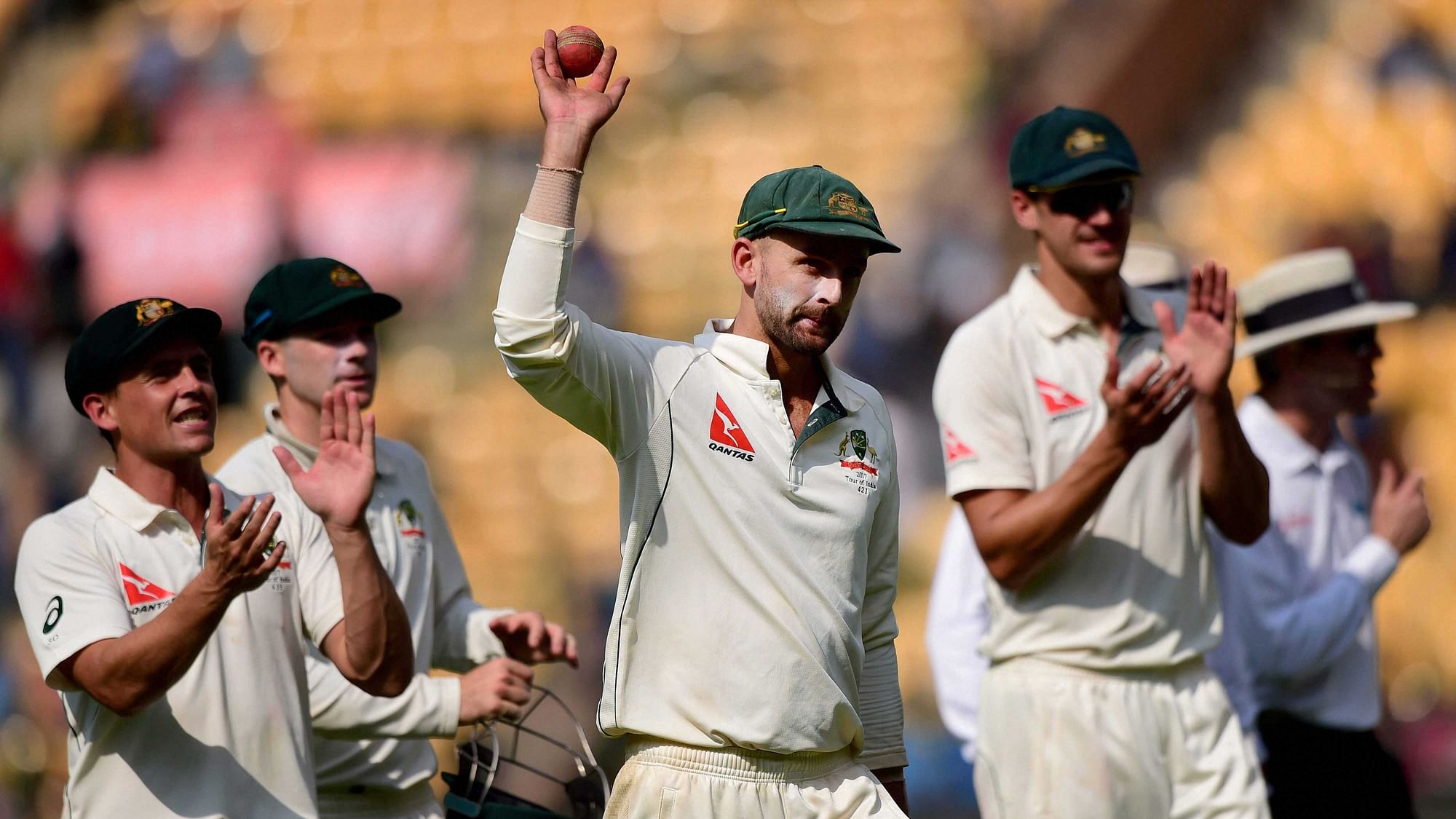 Australia’s Nathan Lyon celebrates with teammates after taking eight wickets during the first day of the second test match against India at Chinnaswamy Stadium. (Photo: PTI)