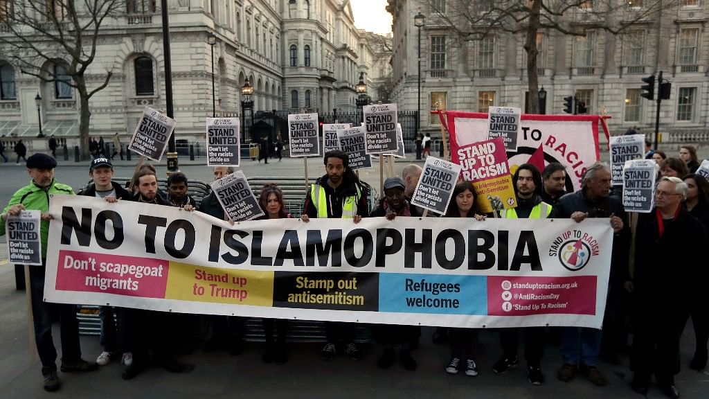 People hold up a banner during a ‘Unity Vigil’ against racism and Islamophobia in London.&nbsp;