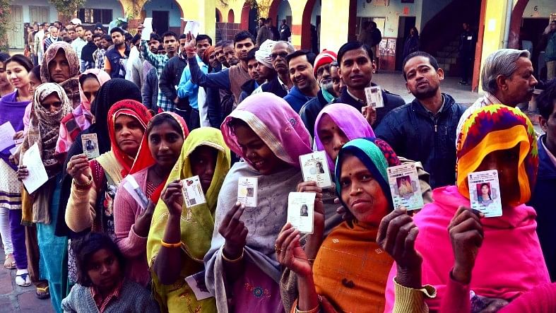People stand in a queue to cast their vote in the first phase of the Uttar Pradesh Assembly elections in Agra on 11 February 2017. (Photo: IANS)