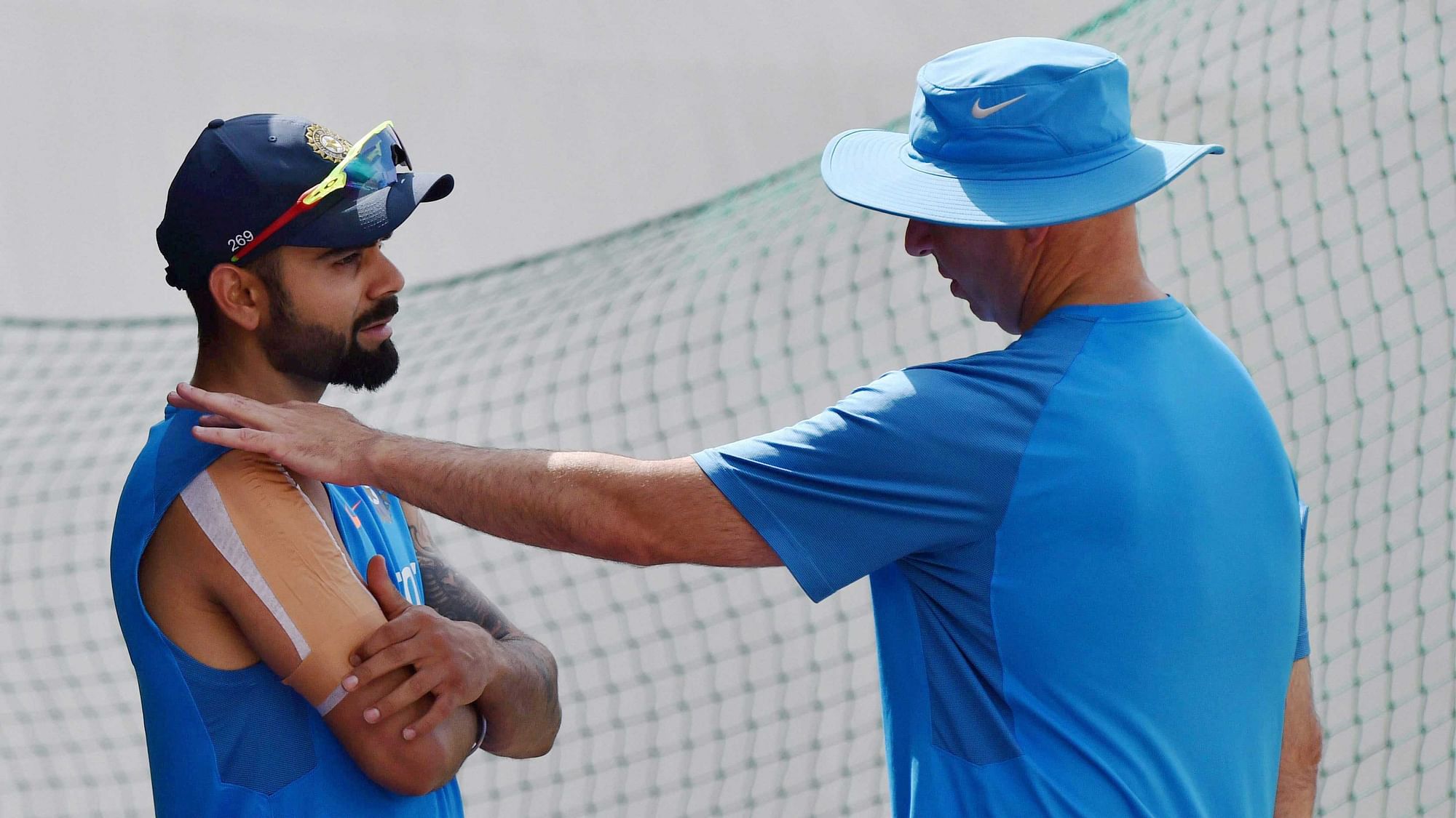 Dharamsala: India’s skipper Virat Kohli with team physiotherapist Patrick Farhart during a practice session at HPCA Stadium in Dharamsala on Thursday. (Photo: PTI)