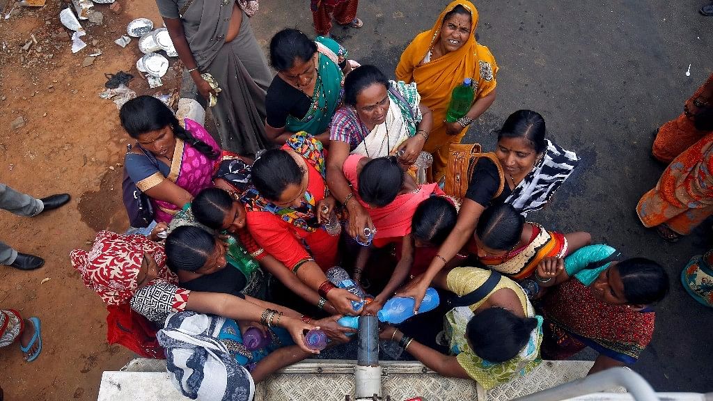 People fill bottles with water from a municipal truck ahead of World Water Day, in Bengaluru. (Photo: Reuters)
